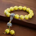 Traditionelles gelbes Glasperlenarmband mit silberner Gebetsmühle und geflochtener Schnur - Gold Sechssilben Mantra