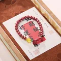 Traditional Chinese beaded bracelet with red cinnabar beads and yellow ruyi pendant - Cinnabar Ruyi Fortune Bracelet