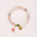 Detail of 8mm violet stone bracelet with gold Fu charm and white flower bead pendant - Chalcedony Peach Blossom Fu Card Style