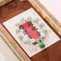 Buddhist beaded bracelet with white lotus carvings and green agate charm on gift card - Green Aventurine Lotus Pod Bracelet