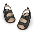 Detail of black faux leather baby sandals featuring velcro straps and soft pebbled texture - 13cm (12-18 Months) / Black