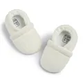 Detail view of cream knit baby shoes showing the soft texture and size markings - 12cm (6-12Months) / Beige