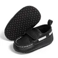 Detail of black infant moccasins with white stitching and non-slip dotted sole - 12-18M / Black