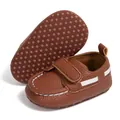 Detail showing the brown baby moccasins with anti-slip dotted sole and velcro strap - 12-18M / Brown