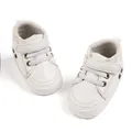 Close-up of white baby sneaker with hook-and-loop strap and soft sole design - 11cm (0-6 Months) / White