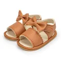 Brown faux leather baby sandals featuring a decorative bow and convenient velcro strap - Brown