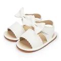 Close-up of white baby girl sandals featuring decorative bow and PU leather texture - 11cm (0-6 Months) / White