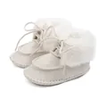 Detail of warm baby winter boots in cream with faux fur lining and lace-up closure - 12cm / Beige