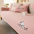 Pink lamb fleece sofa cushion with cute puppy embroidery and woof text in home setting - 70x70cm / Pink