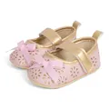 Detail view of baby princess shoes with pink bow, gold trim, and floral cutouts - 0-6 Months / Pink