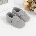 Detailed close-up of grey suede baby moccasins featuring elegant fringe tassels - 11cm / Gray