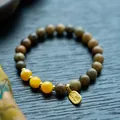 Macro shot of sandalwood beads bracelet with Hetian jade gourd and Nafu charm detail - 8mm / Green Sandalwood & Beeswax Blessing