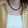 Detailed view of 6mm natural black onyx beaded necklace worn on a yellow linen shirt - 6mm Round Bead Hot Style / 6MM Black