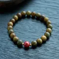 Macro view of sandalwood beads with Hetian jade gourd and red cinnabar center bead - 8mm / Green Sandalwood & Emperor Cinnabar