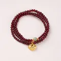 Three-layer garnet bead bracelet featuring a golden lock charm and green jade bead - Qingshui Hetian Jade & Lucky Lock Style / 4mm Bead Diameter / Triple-Wrap / Burgundy