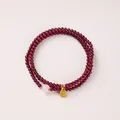 Three-layer garnet beaded bracelet with pink bead and golden Fu pendant - White Hetian Jade & Fu Tag Style / 3mm Bead Diameter / Triple-Wrap / Burgundy