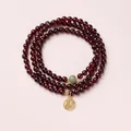 Three-layer garnet bracelet with green jade bead and golden Fu character lucky pendant - Hetian Jade & Fu Tag Design Style / 5mm Bead Diameter / Triple-Wrap / Burgundy