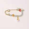 Detail of a vintage gold horse brooch pin with colorful woven thread and jade bead charm - Persimmon Fortune Style Brooch