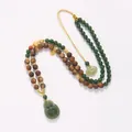 Detailed close-up of Hetian jade Buddha pendant and sandalwood beads on a woven necklace - Hetian Jade Agarwood Buddha Necklace