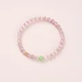 Pink and purple cats eye beaded bracelet with gold metal accent on pink background - Monet Pink Cat's Eye Green Chalcedony (6mm)