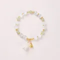 Elegant cat eye stone bracelet with lily of the valley charm and gold bell accents - Cat's Eye Nephrite Jade Lily of the Valley
