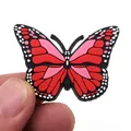 Detailed view of a red butterfly PVC shoe charm accessory for clogs and DIY projects - Pink Butterfly Style (2)