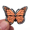 Detail shot of a realistic orange PVC butterfly shoe charm for clogs with a black border - Orange Butterfly Style (3)