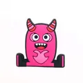 Detail of a bright magenta cartoon monster shoe charm with a heart-shaped hand gesture - Magenta Monster Making Heart Gesture (16)