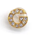 Golden alloy letter G charm featuring sparkling pavé crystals and secure silicone back - Letter G