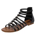 Bohemian black gladiator flat sandals with gold bow accents and rear zipper closure - EU 36 / Black
