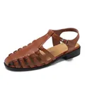 French style brown woven hollow flat sandals with adjustable ankle strap and silver buckle - EU 35 / Brown