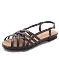 Women's woven brown gladiator flat sandals with cross straps and buckle closure - Coffee
