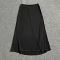Close-up of black A-line maxi skirt with elastic waistband on grey textured carpet - S / Black Midi Skirt