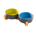 Dual ceramic cat bowls in blue and yellow colors with a minimalist bamboo stand - Two Small Green And Blue Bowls And Wood Stand