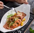 White boat-shaped ceramic serving plate with handles featuring fresh shrimp and salad - Double Handle Baking Pan / White