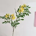 Artificial yellow jasminum flowers with green leaves in a home decor setting - Yellow