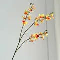 Artificial vanda orchid branch in vibrant orange-yellow gradient with realistic stems - Orange