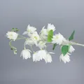 Close-up of white artificial lily of the valley flowers with flocked grey stems and buds - White