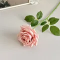 Realistic pale pink artificial rose stem with green leaves on a minimalist table - Autumn Pink