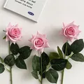 Three premium pink moist-feel artificial roses with green leaves on white background - Deep Pink
