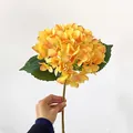 Faux hydrangea in orange yellow gradient with green leaves and realistic brown stem - Orange