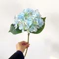 Single light blue artificial hydrangea stem with realistic silk petals and green leaves - Blue