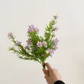 Faux baby's breath bundle featuring purple and white flowers with green needle-like leaves - Light Purple