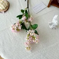 Delicate pink gradient artificial lilac branch with realistic green leaves on white cloth - Pink