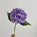 Realistic 3D purple faux hydrangea stem with textured petals and green leaves for decor - Purple