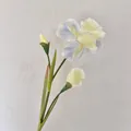 Artificial iris flower with blue petals and cream accents on a green stem - Broken Ice Blue