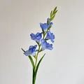 Vibrant blue artificial gladiolus stem with lifelike petals and green leaves - Blue