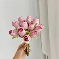 Pink artificial silk rose bouquet tied with twine held against a minimalist background - Dusty Pink