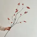 Artificial red holly berries branch held by hand for elegant home vase decoration - Long Orange
