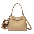 Beige pebbled leather bucket bag with metal buckle and cute plush charm detail - Khaki